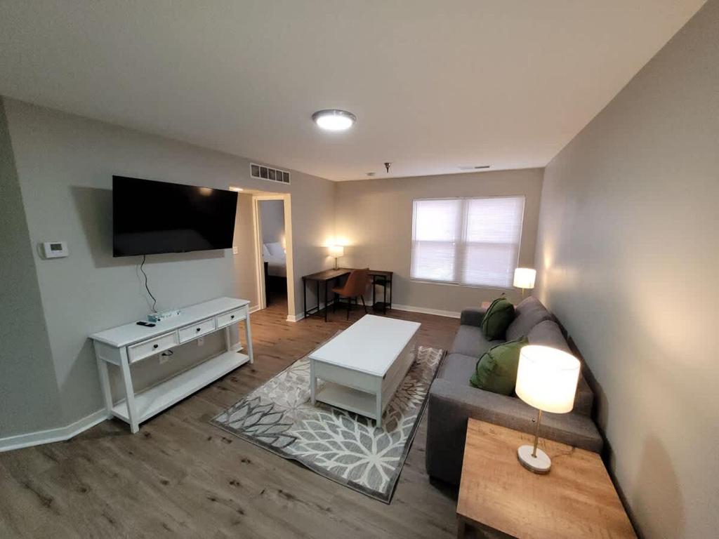 a living room with a couch and a flat screen tv at Aksarben Gem-Easy access to I-80 in Omaha