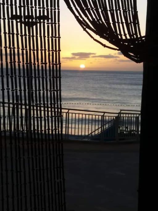 a view of the ocean from a window of a beach at Casa cueva primera línea playa in Gáldar