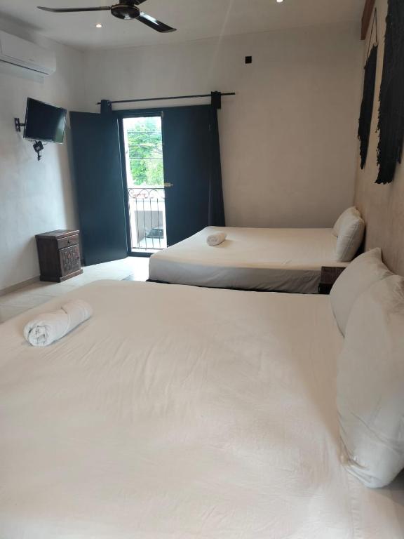 Postel nebo postele na pokoji v ubytování Hotel Casa Henequén
