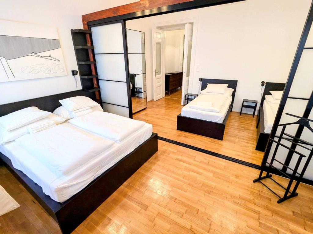 a bedroom with two beds and a mirror at Ó 38 Family Luxe in Budapest