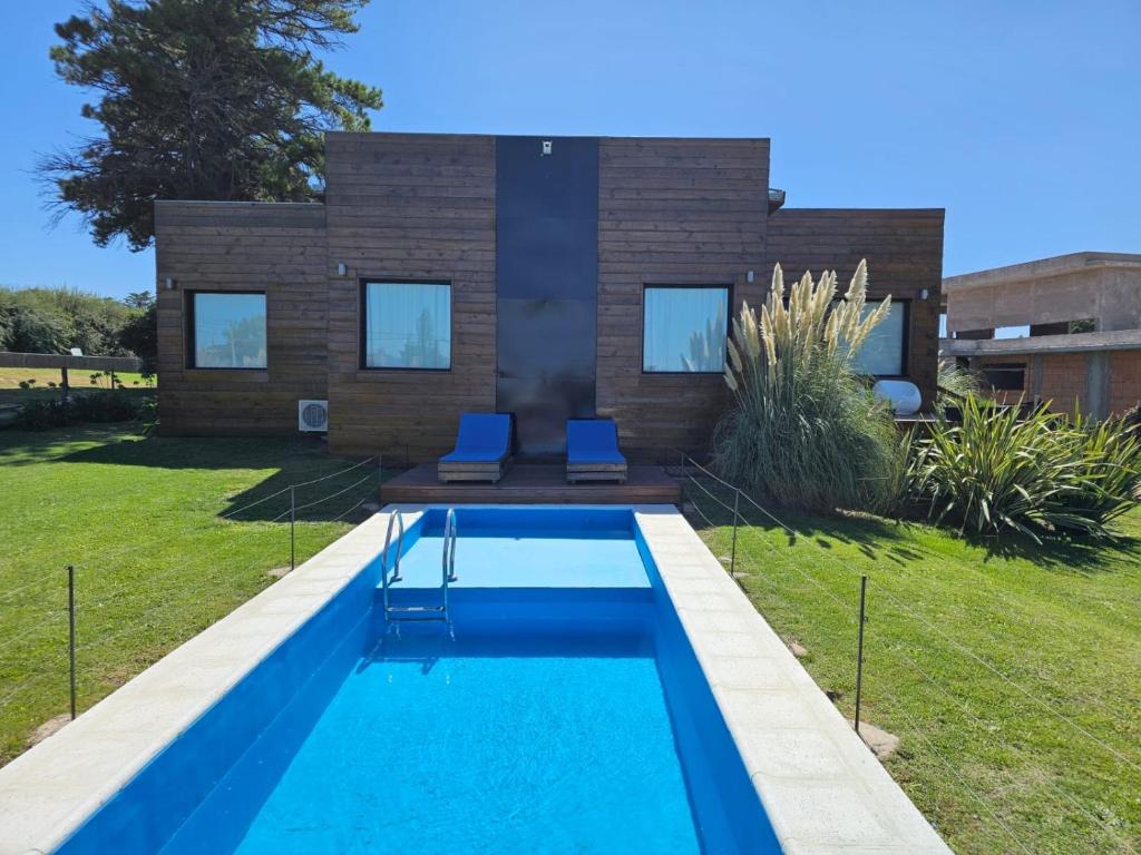 a swimming pool in front of a house at Casa Cortés Golf - Boutique in Sierra de la Ventana