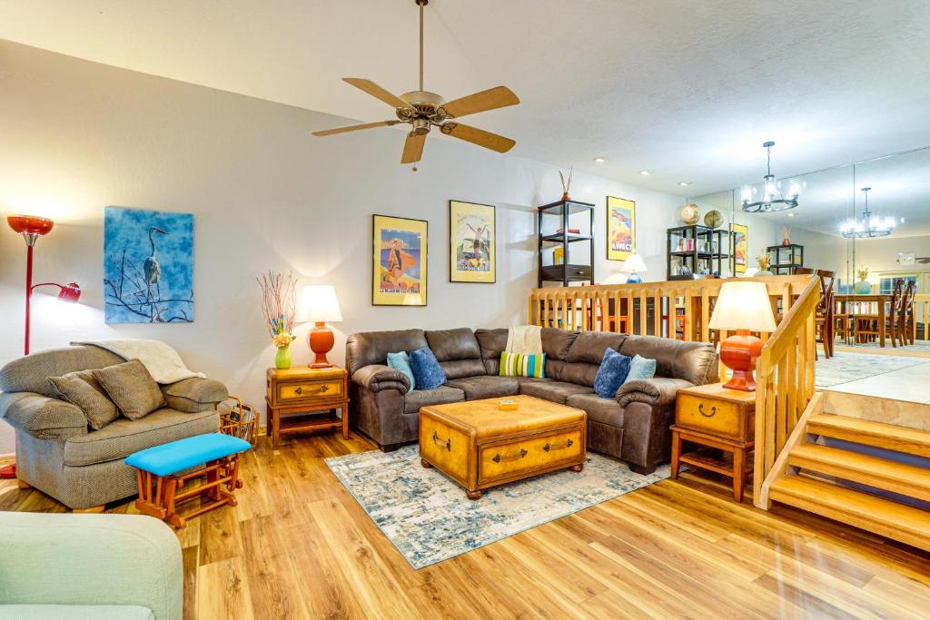 a living room with a couch and a table at Sunny Titusville Retreat Near Space Coast! in Titusville