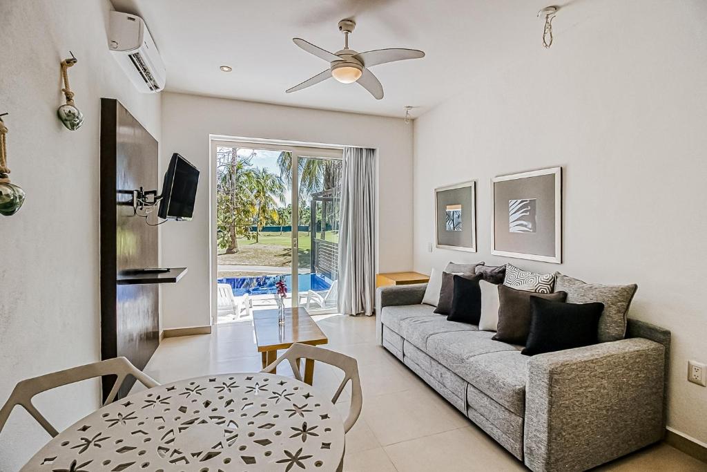 a living room with a couch and a table at Taheima 2104B at El Tigre in Nuevo Vallarta 