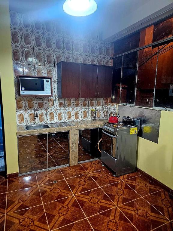 a kitchen with a stove and a counter top at La Casa de las 7 Esquinas in Puno