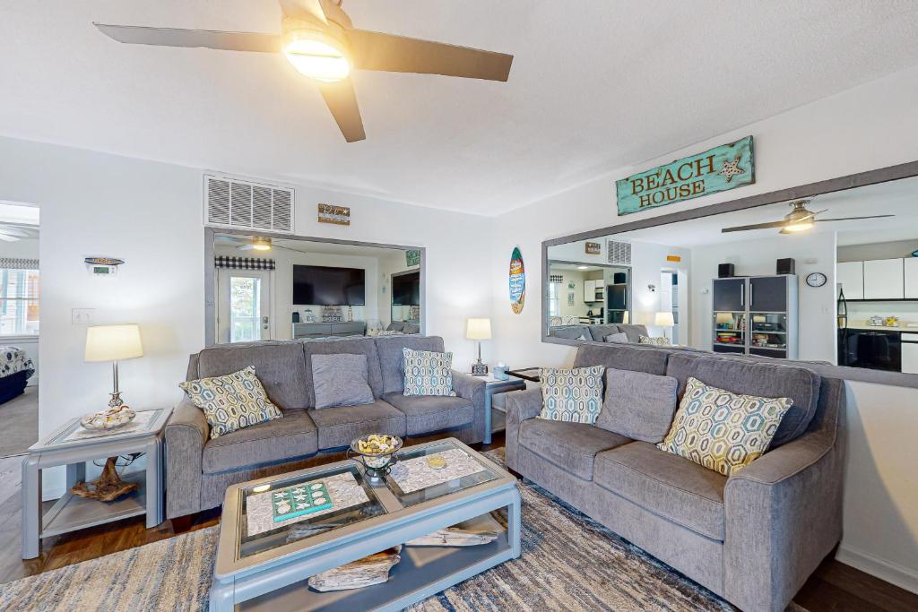a living room with two couches and a table at Marathon North 103 in Ocean City