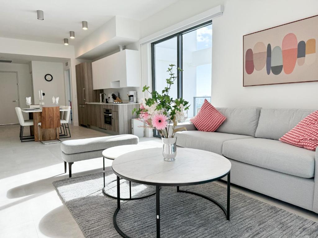 a living room with a couch and a table at Private Terrace in Luxury 3BR Condo in Brickell in Miami