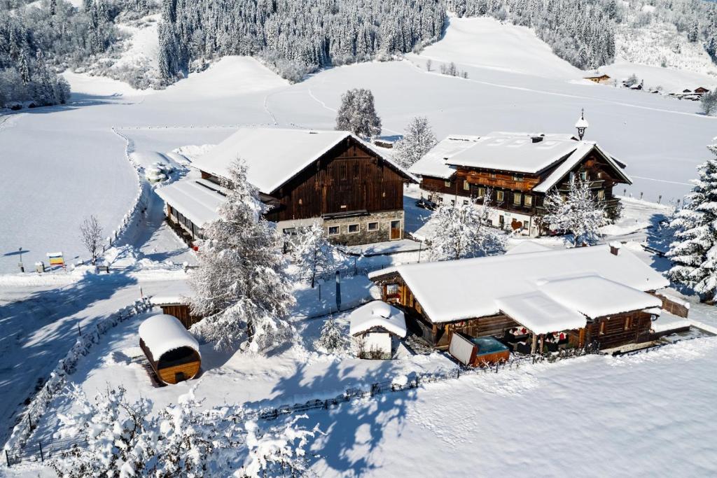 a house covered in snow in the mountains at Aignerhof in Flachau