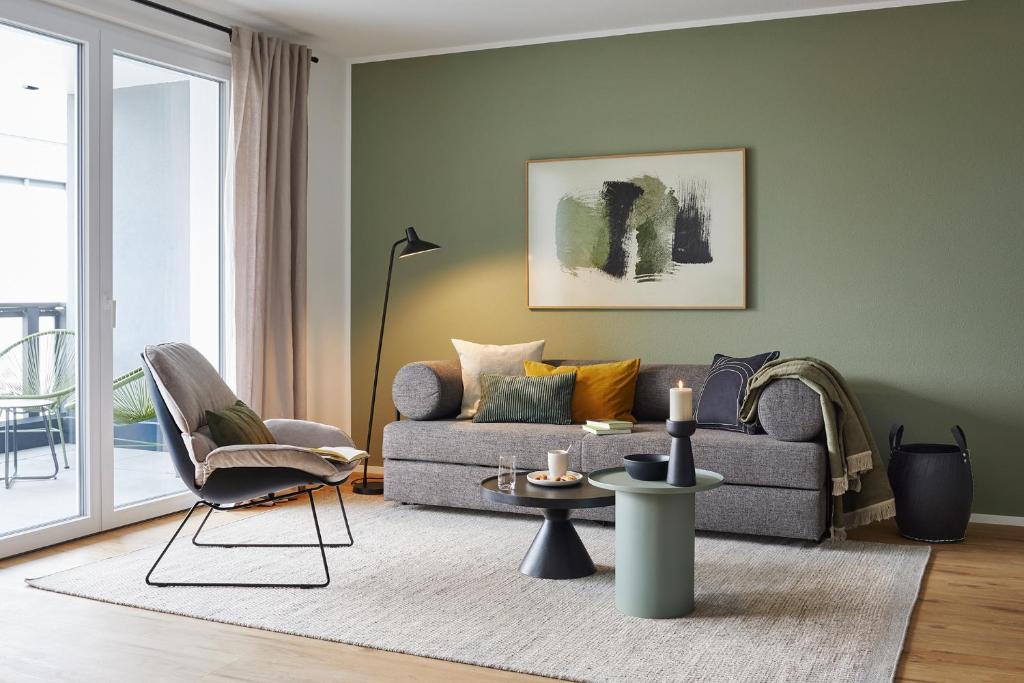 a living room with a couch and a chair at MATT - Apartments ' Design-Apartment mit Balkon in Villingen-Schwenningen