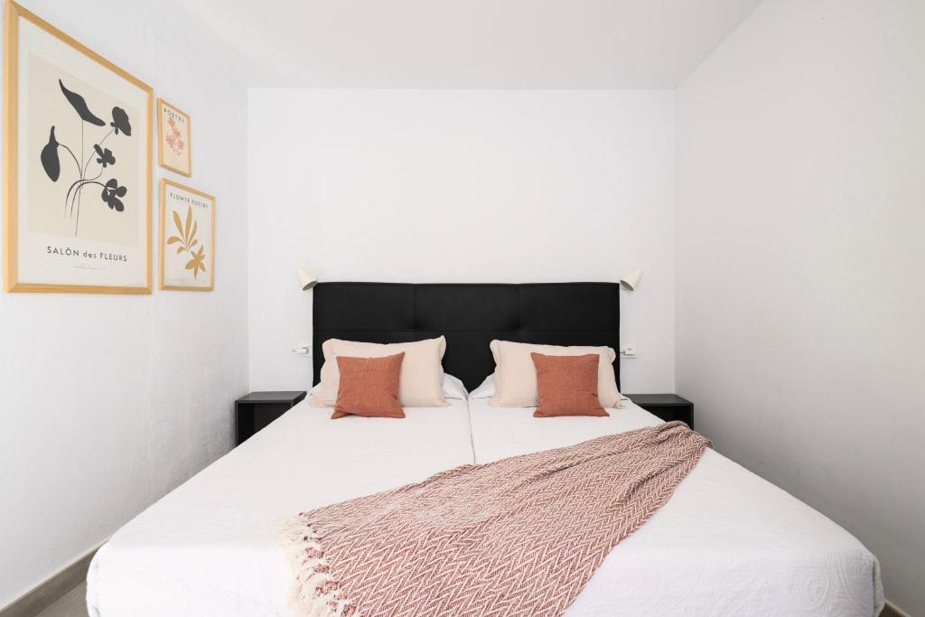 Posteľ alebo postele v izbe v ubytovaní Vegueta Rooftop Suites