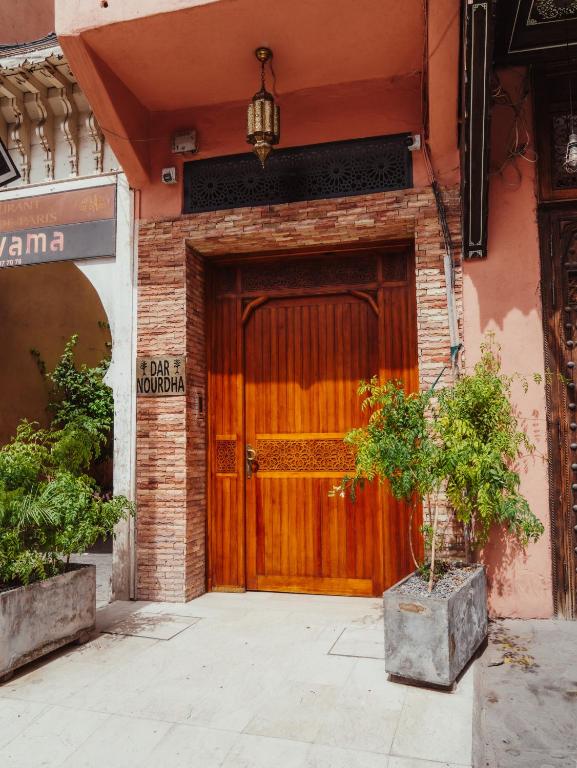 a wooden door on the side of a building at Dar Nourdha in Marrakesh