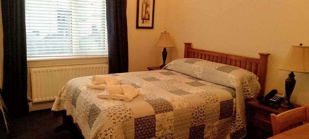 Postel nebo postele na pokoji v ubytování Ash Grove House
