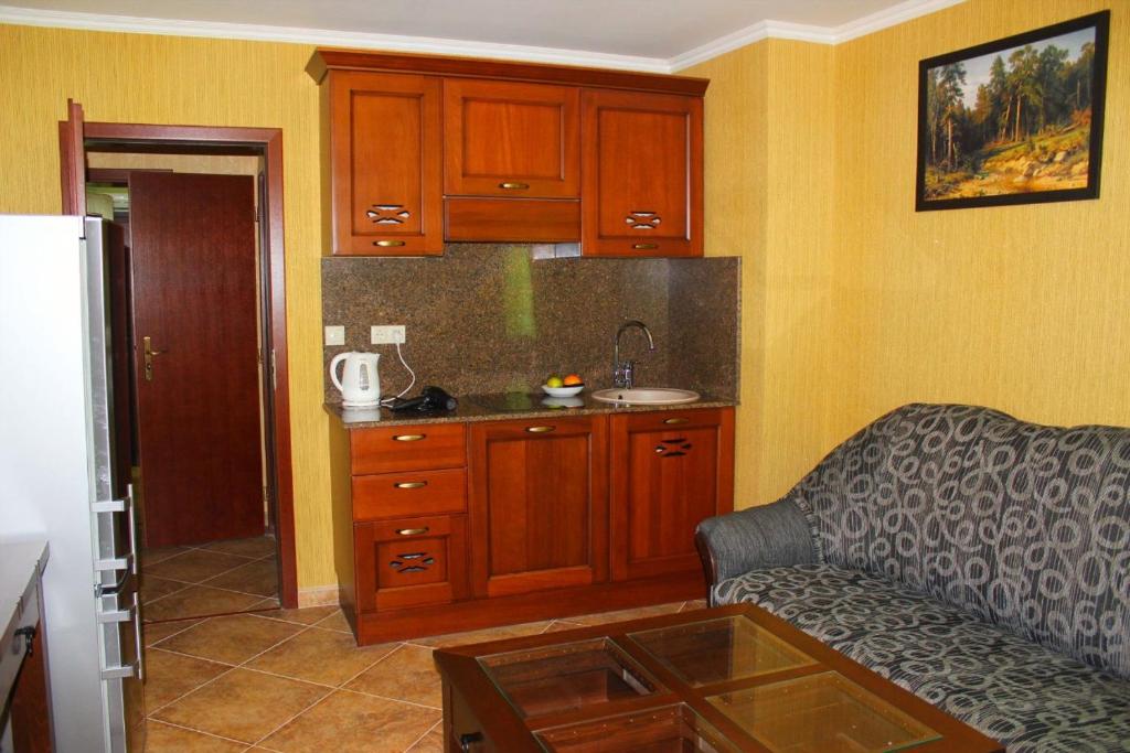 a living room with a couch and a kitchen at Villa Katalina in Varna City