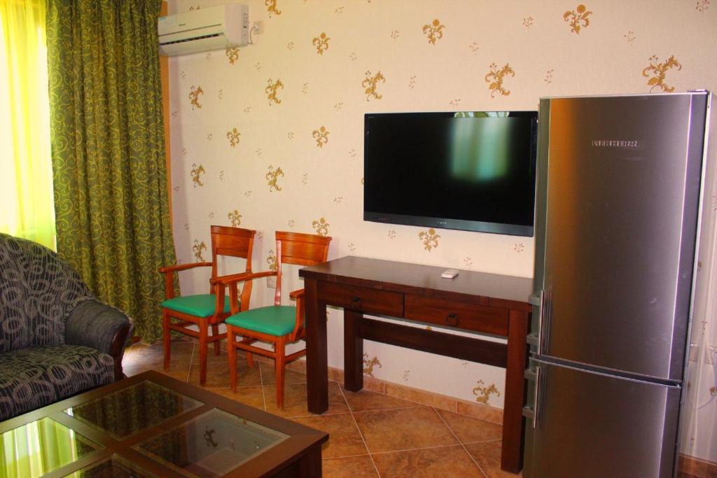 a living room with a refrigerator and a table with chairs at Villa Katalina in Varna City