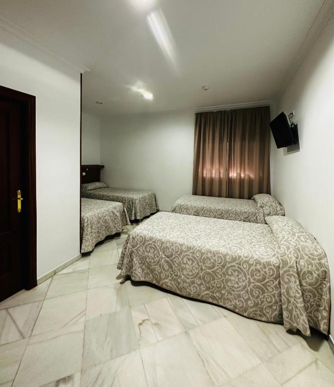 Postel nebo postele na pokoji v ubytování Hotel Quitagolpe