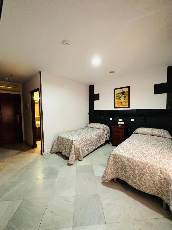 Postel nebo postele na pokoji v ubytování Hotel Quitagolpe