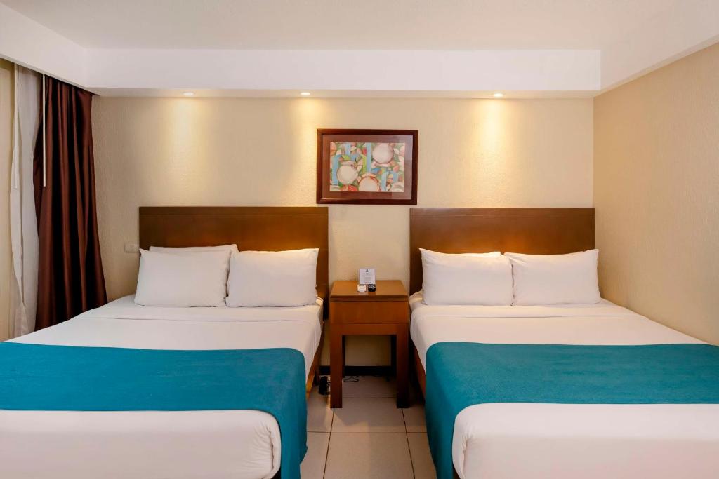 Postel nebo postele na pokoji v ubytování Best Western Jaco Beach All Inclusive Resort
