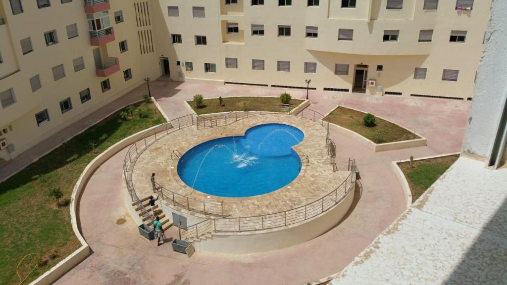 an overhead view of a swimming pool in the middle of a building at Appartement Alkheir in Agadir