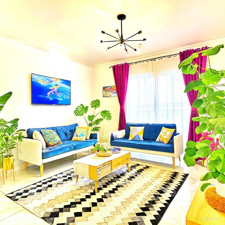 a living room with two blue couches and a table at cozy cozy in Madinaty