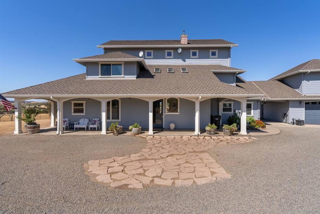 a large house with a stone driveway in front of it at Whispering Oaks Manor-Pets Ok, Spa, Game room in Paso Robles
