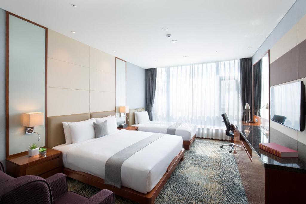 Postel nebo postele na pokoji v ubytování I Square Hotel