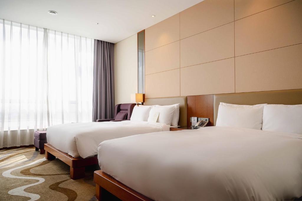 Postel nebo postele na pokoji v ubytování I Square Hotel