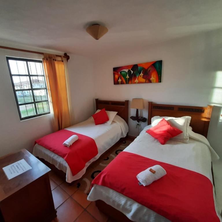 Postel nebo postele na pokoji v ubytování Aparta Hotel El Refugio de María