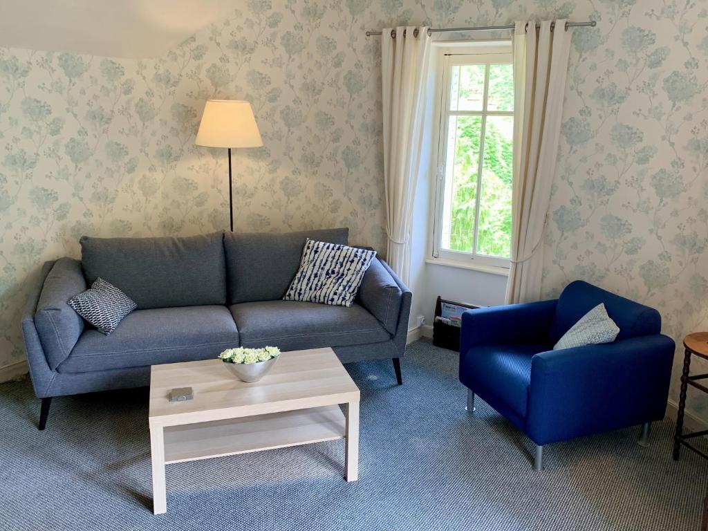 a living room with a couch and two chairs at Villa in Saint-Nectaire near Ski Slopes in Saint-Nectaire
