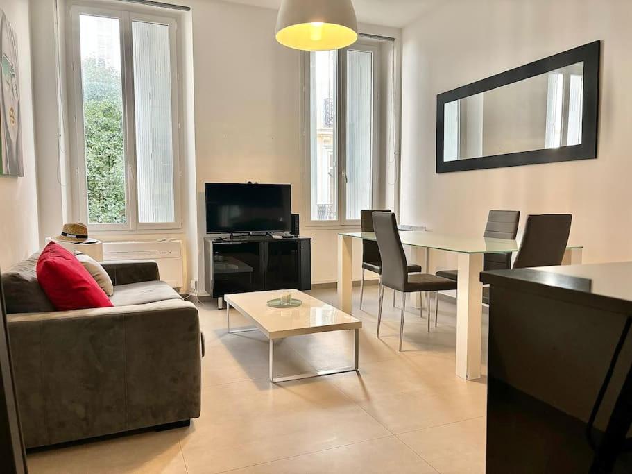 un salon avec un canapé et une table dans l'établissement Cannes Appartement 1 chambre - 26H, à Cannes