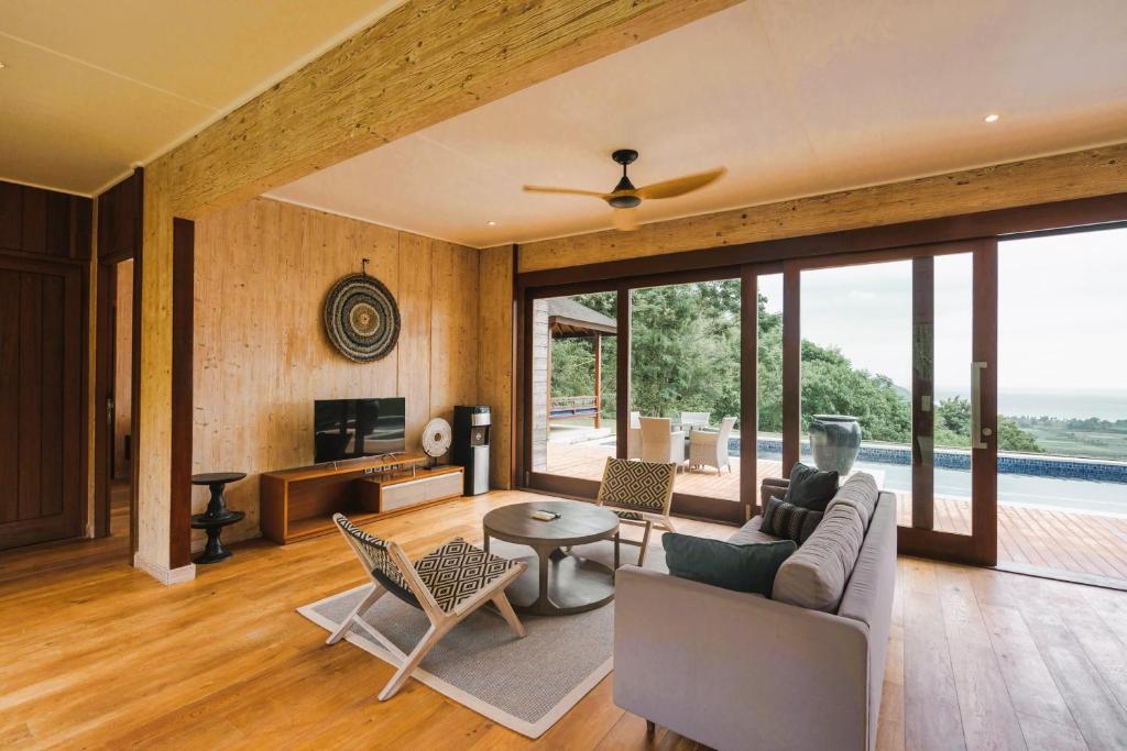a living room with a couch and a table at Selong Selo Resort and Residences in Selong Belanak