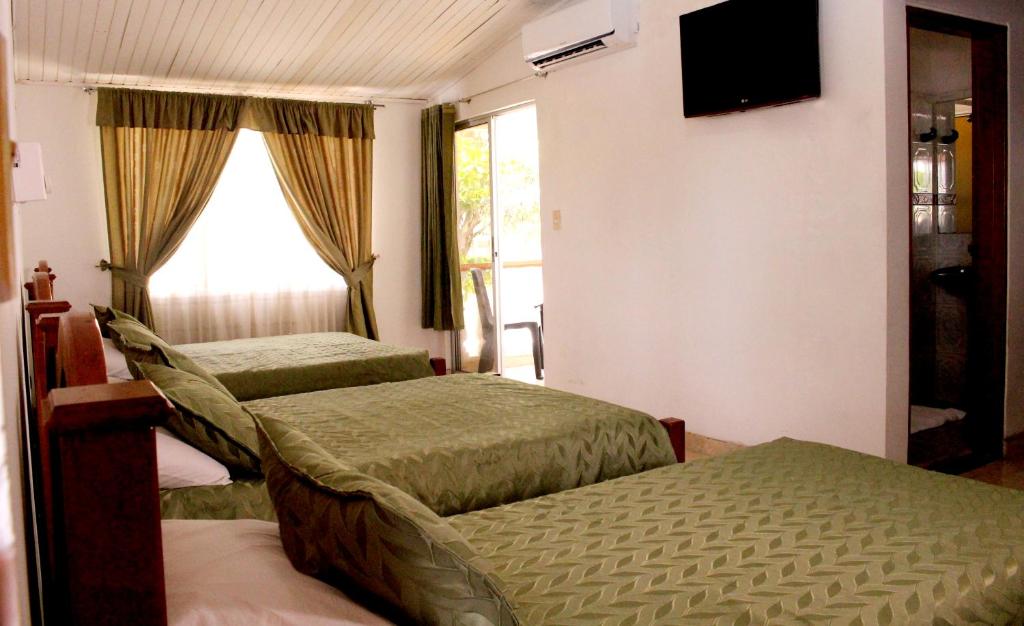 Postel nebo postele na pokoji v ubytování Alborada Hotel Melgar