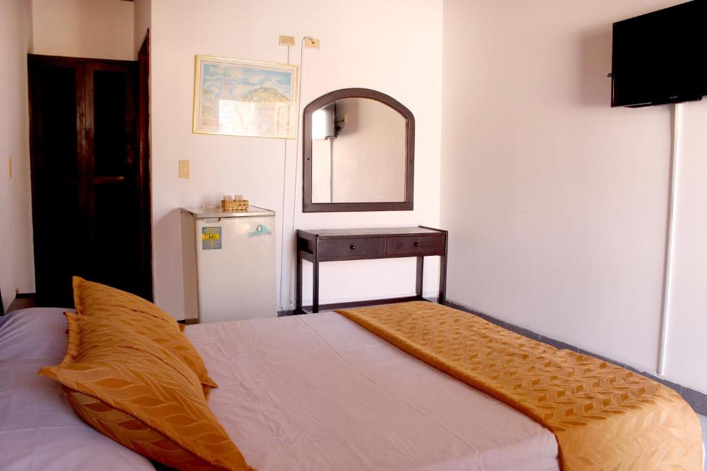 Postel nebo postele na pokoji v ubytování Alborada Hotel Melgar