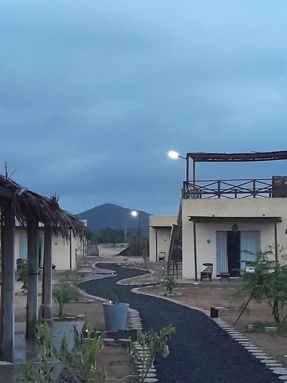 a view of a house with a mountain in the background at Tres Velas Surf in Celestino Gasca