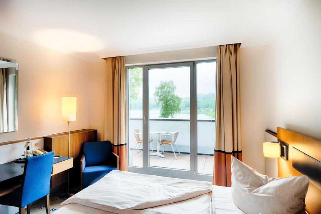 Ein Bett oder Betten in einem Zimmer der Unterkunft Welcome Hotel Meschede Hennesee