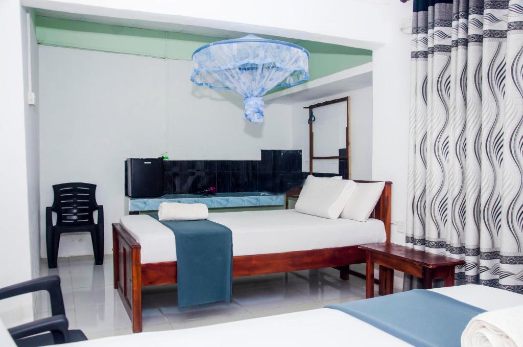 Postel nebo postele na pokoji v ubytování Triangle Home Stay