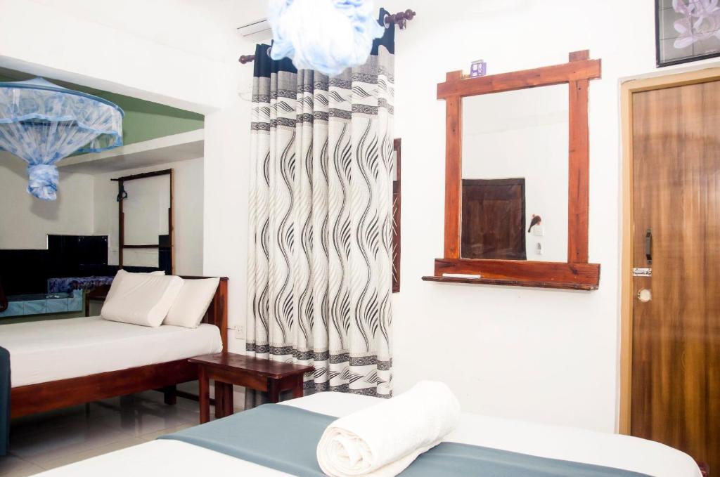 Postel nebo postele na pokoji v ubytování Triangle Home Stay