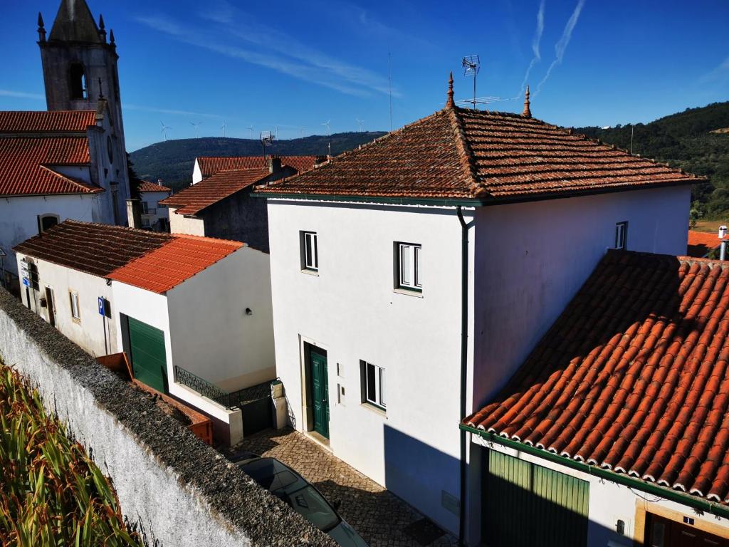 a group of white buildings with red roofs at Casa de Penela in Penela