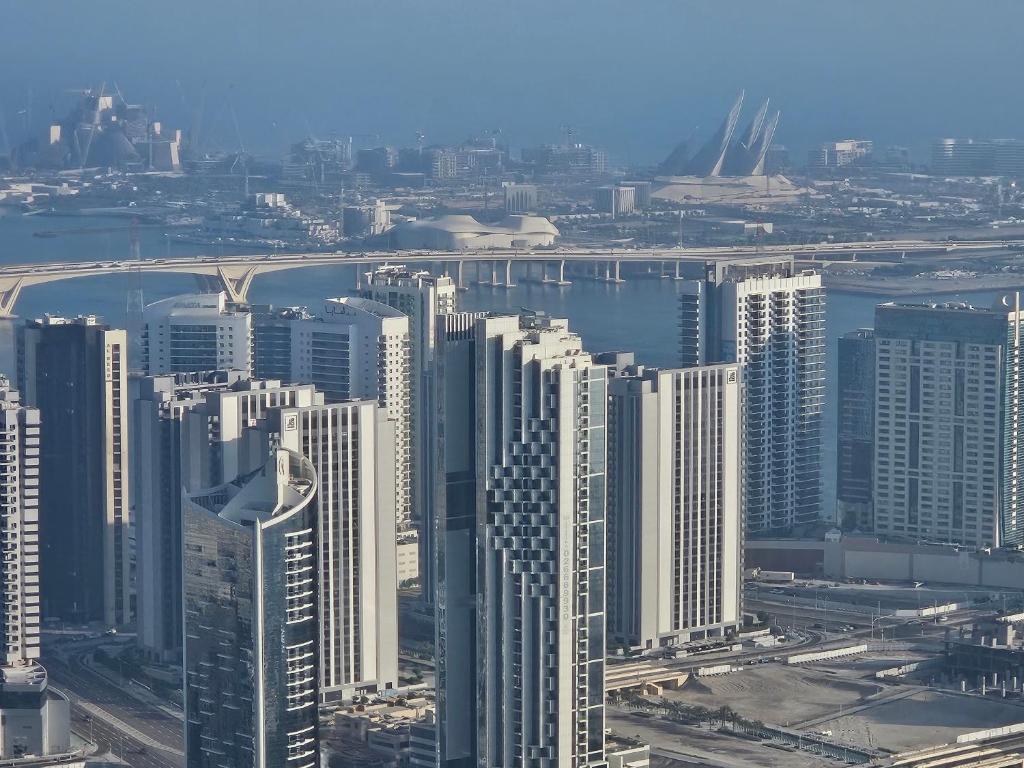 an aerial view of a city with tall buildings at C-Suite Views at Al Reem and Al Maryah Island in Abu Dhabi
