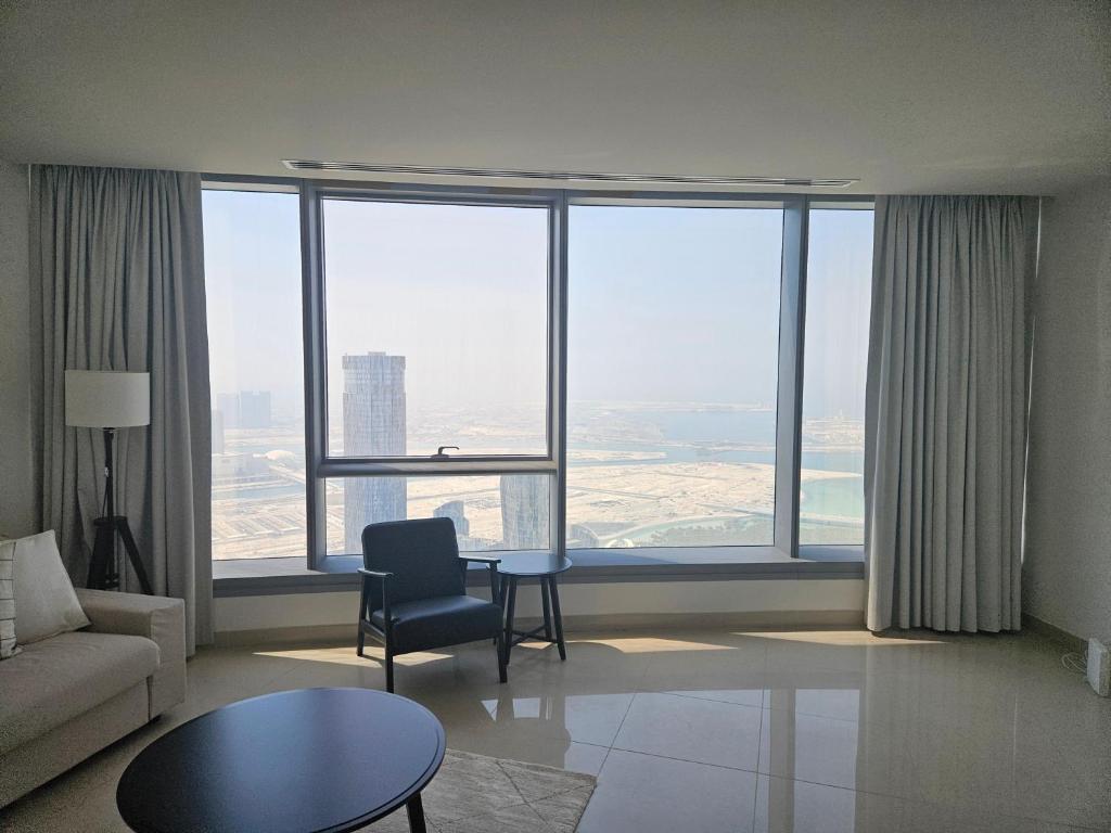 a living room with a couch and a table at C-Suite Views at Al Reem and Al Maryah Island in Abu Dhabi
