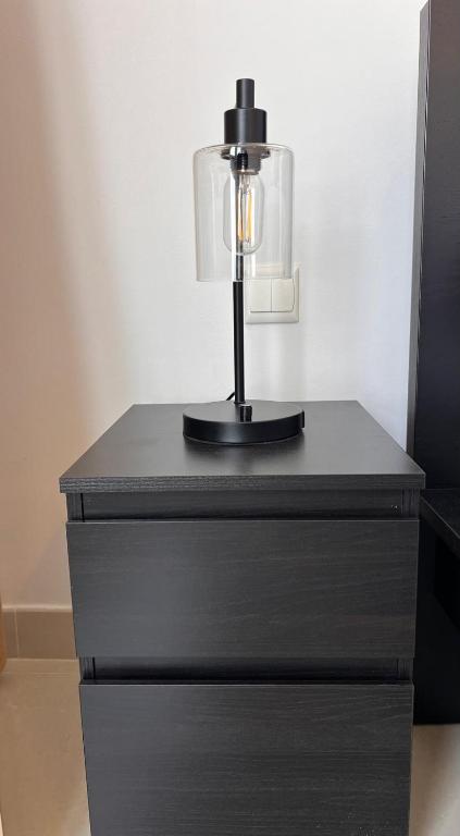 a table with a lamp on top of a dresser at C-Suite Views at Al Reem and Al Maryah Island in Abu Dhabi