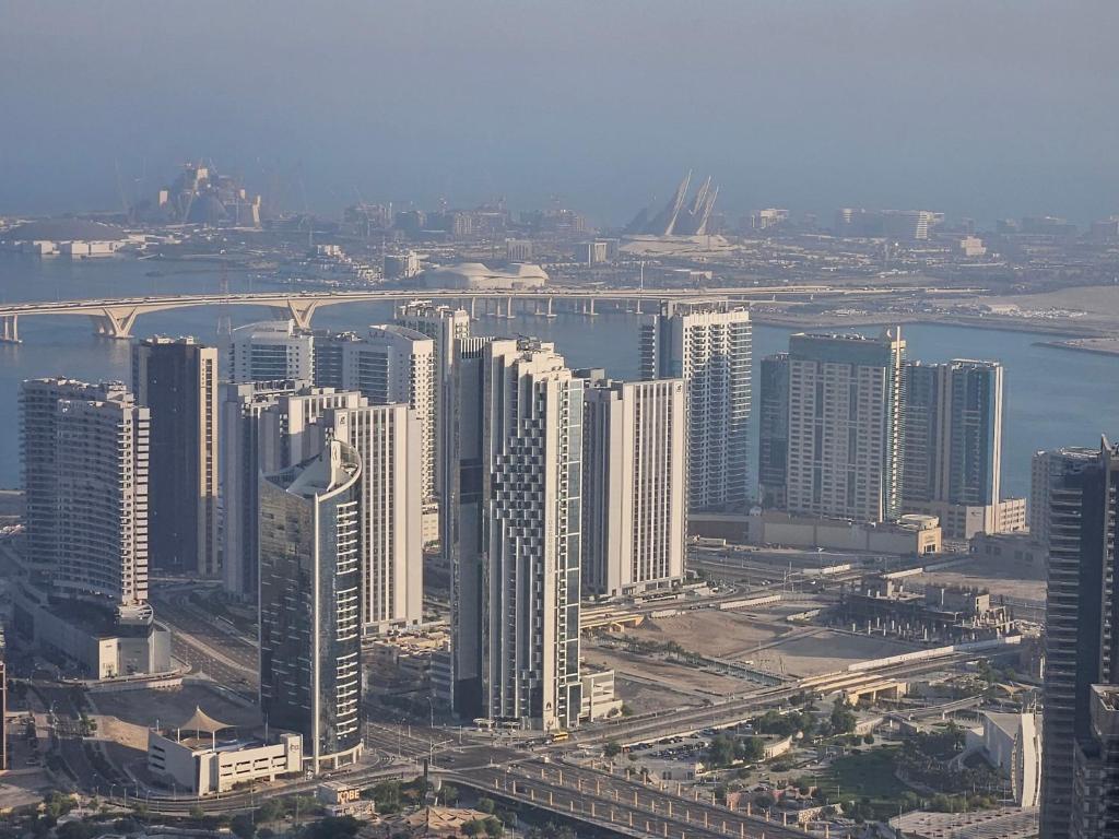 an aerial view of a city with tall buildings at C-Suite Views at Al Reem and Al Maryah Island in Abu Dhabi