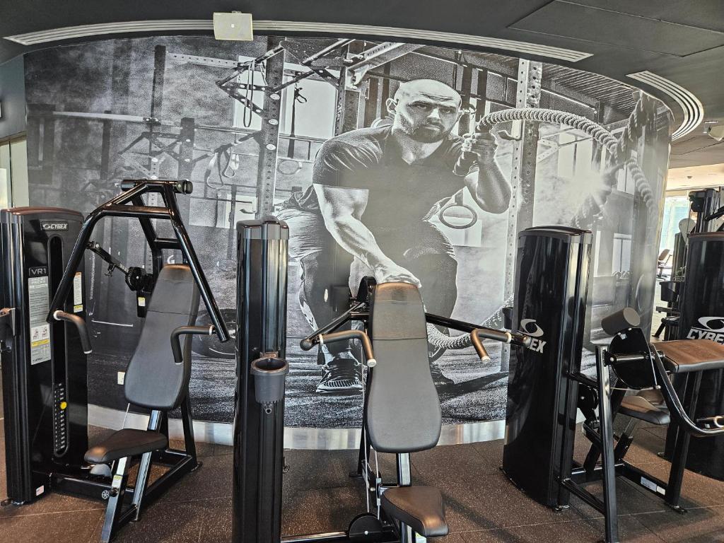 a gym with a picture of a man on the wall at C-Suite Views at Al Reem and Al Maryah Island in Abu Dhabi