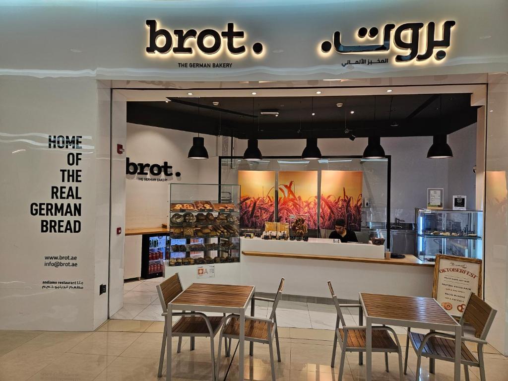 a restaurant with two tables and chairs in a store at C-Suite Views at Al Reem and Al Maryah Island in Abu Dhabi