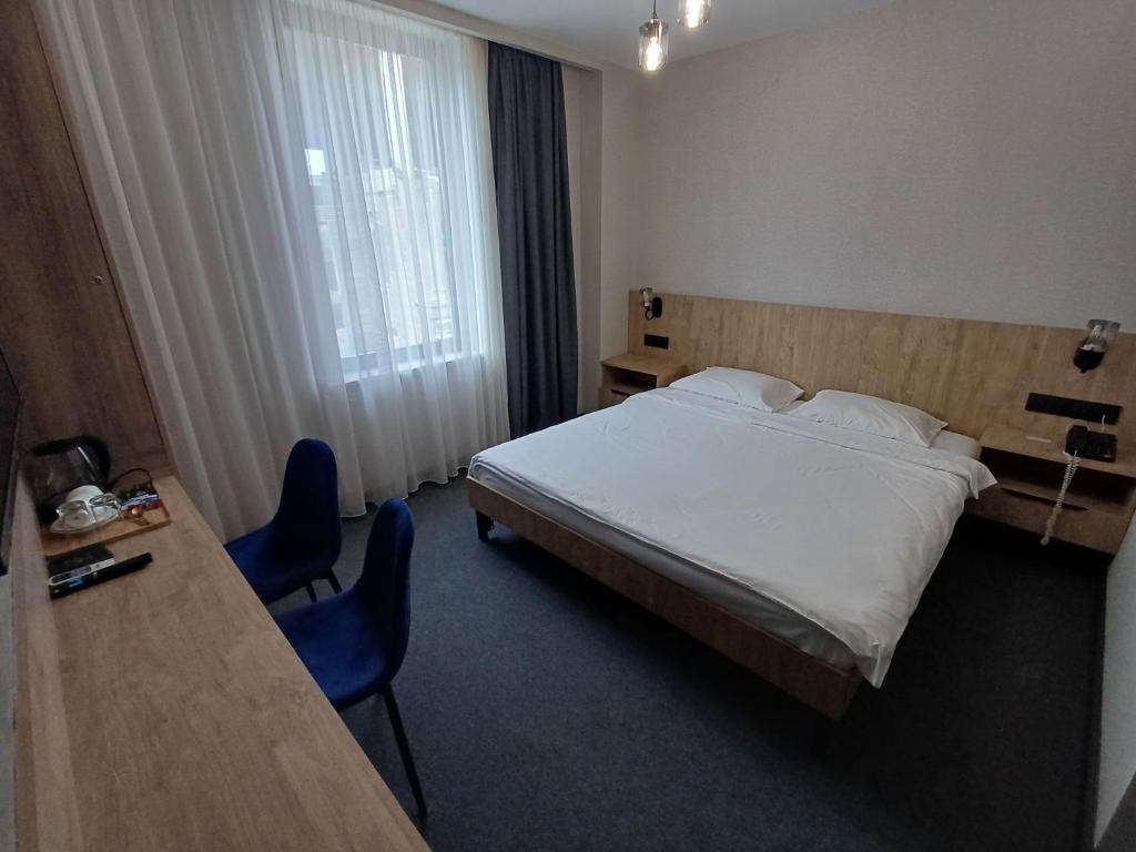 Postel nebo postele na pokoji v ubytování Old Avenue Hotel