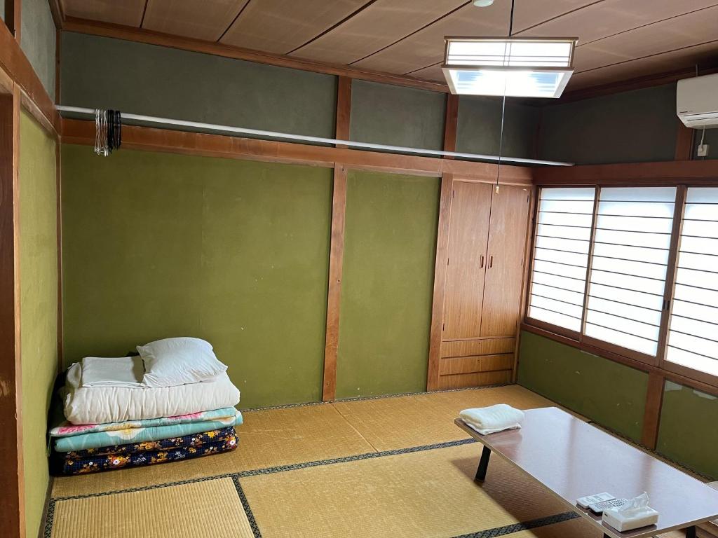 Postel nebo postele na pokoji v ubytování ふる里 Mt Fuji Inn Furusato