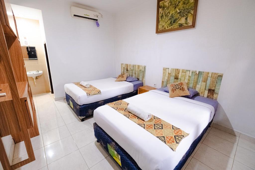 Postel nebo postele na pokoji v ubytování Apartmen Kak Okoh