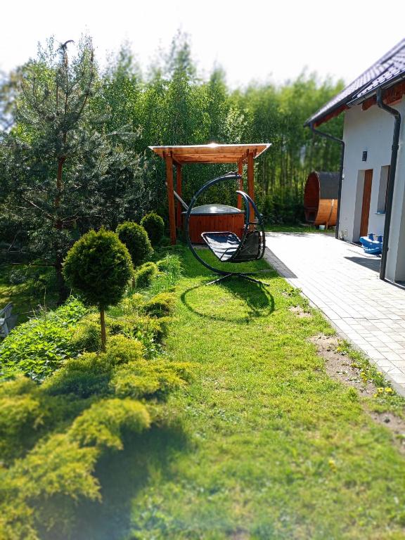 a garden with a gazebo in the grass at Willa w Brzozach Sznurki Spokojna 1 - Chmielno, Kaszuby, dom, jezioro in Chmielno