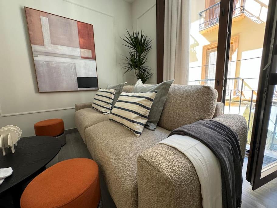 a living room with a couch and a table at Navas 202 Elegant Suite in Granada