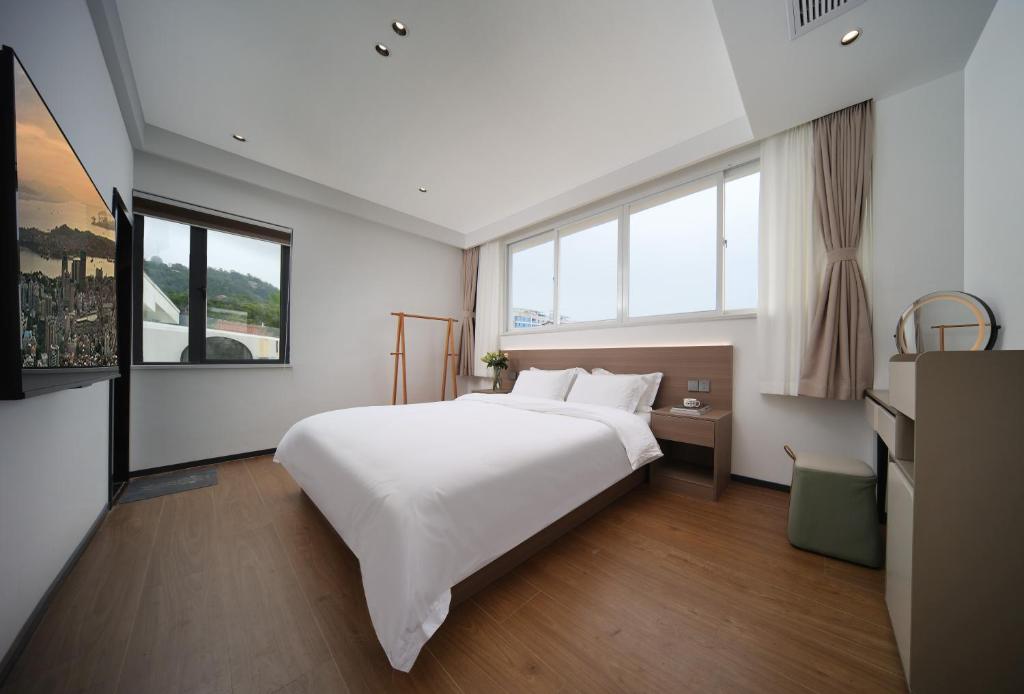 Postel nebo postele na pokoji v ubytování 贵客心宿 Xiamen Guike Xinsu
