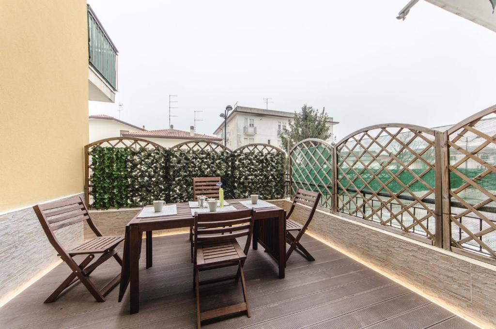 a dining table and chairs on a balcony at Residence Daytona Appartamento due camere in Caorle