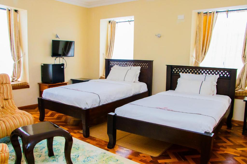 Postel nebo postele na pokoji v ubytování The Blixen Resort & Spa